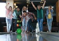 Man throwing ball and spending time with friends in bowling Royalty Free Stock Photo