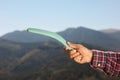 Man throwing boomerang in mountains, closeup view