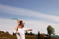 Man throwing boomerang outdoors on sunny day. Space for text