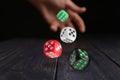 Man throwing dice on black wooden table, closeup Royalty Free Stock Photo