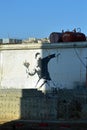 Man throwing flowers by Banksy