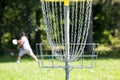 Man throwing frisbee playing disc golf in the park