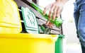 Man throwing the glass bottle andtin can into differennt dustbins Royalty Free Stock Photo