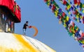 Man throwing orange paint on Boudhanath stupa Royalty Free Stock Photo