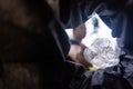 Man throws garbage into a garbage can on the street. With a worm view from the inside of the trash bin. Selective focus Royalty Free Stock Photo