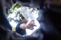 Man throws garbage into a garbage can on the street. With a worm view from the inside of the trash bin. Selective focus Royalty Free Stock Photo