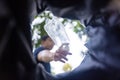 Man throws garbage into a garbage can on the street. With a worm view from the inside of the trash bin. Selective focus Royalty Free Stock Photo