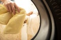 A man throws laundry into a washing machine.Everyday household chores Royalty Free Stock Photo