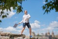 Man throws notebook against blue sky