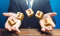 Man throws 5 numbered blocks with the numbers one two three four five from his hands. Five easy steps. Organization Royalty Free Stock Photo