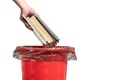 A man throws an old books into the trash bin. Male hand throws outdated book into trash isolate on white background close-up Royalty Free Stock Photo