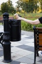 man throws a paper cup into the trash Royalty Free Stock Photo