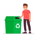 Man throws a plastic bottle into the trash can. The concept of caring for the environment and sorting garbage