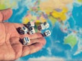 A man throws seven dice on the world map. The concept of ownership of the world. World order.d map and money Royalty Free Stock Photo