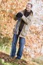 Man tidying leaves in garden