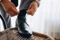 Man ties his shiney new black leather business shoes