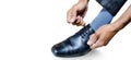 Man ties the laces on his polished shoes. Business formal dress style Royalty Free Stock Photo