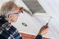 Man tightening the bolts on ventilation grille Royalty Free Stock Photo