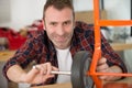 man tightening wheel on sack truck