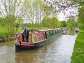 Man steering canal narrowboat