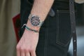 Man with Timex watch and fabric bracelets before Emporio Armani fashion show, Milan Fashion Week street style on