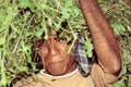 Man from Timor carrying plants after harvest