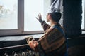 Man in tinfoil cap looking out the window, UFO Royalty Free Stock Photo