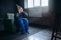 Man in tinfoil cap watch TV, telepathy phobia Royalty Free Stock Photo