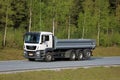 MAN Tipper Truck on Motorway with Forest Background