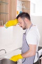 Man tired of washing dishes Royalty Free Stock Photo