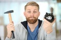 man about to break ceramic piggy-bank with hammer Royalty Free Stock Photo