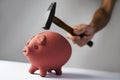 Man about to break a piggy bank with a hammer Royalty Free Stock Photo