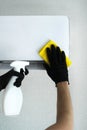 A man to clean the air conditioner at home with gloves with a special tool. cleaning company for cleaning. air conditioner cleanin