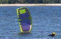 Man about to start kite boarding as the wind fills the kite