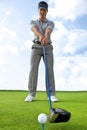 Man about to strike golf ball, low angle view Royalty Free Stock Photo