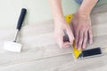 Man with Tools to Laying Laminate