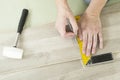 Man with Tools to Laying Laminate