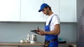 Man with tools writing report inspecting kitchen on electrical safety, service Royalty Free Stock Photo