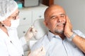 Man with toothache at the dentist