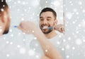 Man with toothbrush cleaning teeth at bathroom Royalty Free Stock Photo