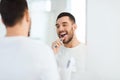 Man with toothbrush cleaning teeth at bathroom Royalty Free Stock Photo