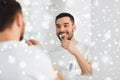 Man with toothbrush cleaning teeth at bathroom Royalty Free Stock Photo