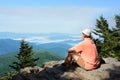 Man a top of mountain enjoying beautiful foggy mountain landscape. Royalty Free Stock Photo