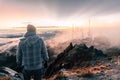 Man on top of a mountain gazing the cloudy views Royalty Free Stock Photo
