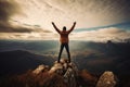 Man on top of the mountain raised hands up. Freedom and success concept, Hiker celebrating success on the top of a mountain, Full Royalty Free Stock Photo