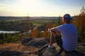 Man on top mountain sitting on rock and look on sunset Royalty Free Stock Photo