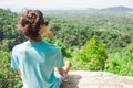 Man on top of mountain sitting on the rock watching picturesque view Royalty Free Stock Photo