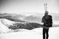 Man on top of mountain in winter