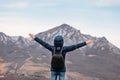 Man on top mountains on background mountains with arms raised in air. view from back Royalty Free Stock Photo