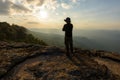 Man on the top of a rock to face the sunset Royalty Free Stock Photo